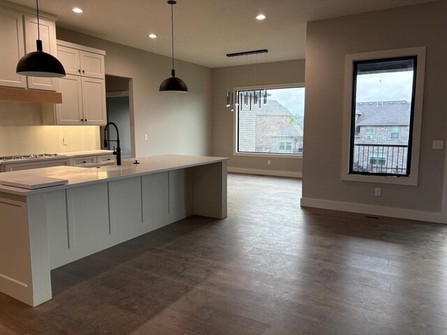 kitchen featuring recessed lighting, a sink, dark wood-style flooring, and light countertops