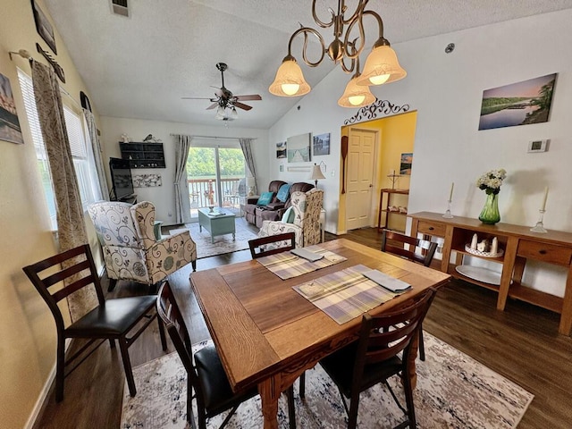 dining area featuring wood finished floors, baseboards, a textured ceiling, a ceiling fan, and vaulted ceiling