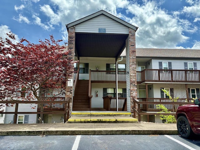 view of building exterior featuring uncovered parking