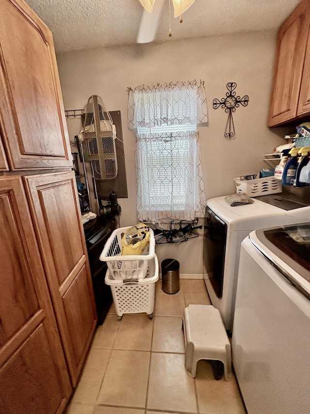 laundry area featuring cabinet space, independent washer and dryer, ceiling fan, a textured ceiling, and light tile patterned floors