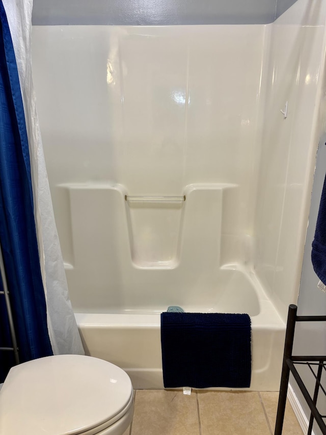 bathroom with tile patterned flooring, toilet, and shower / bath combination with curtain