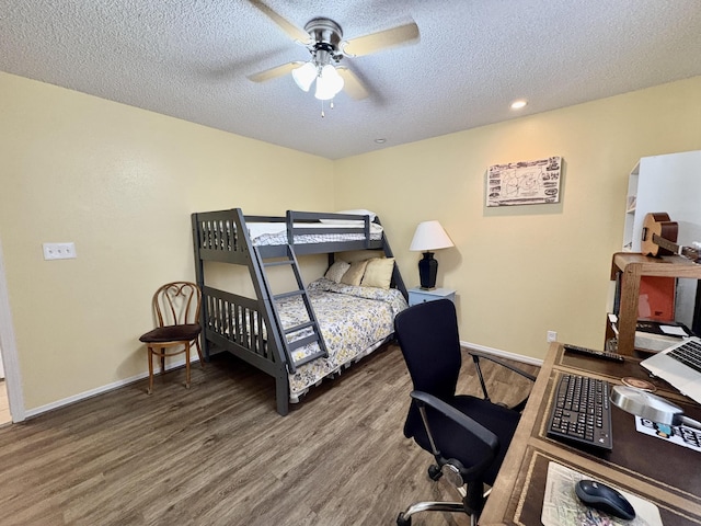 bedroom featuring ceiling fan, a textured ceiling, wood finished floors, baseboards, and recessed lighting