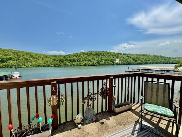 exterior space with a water view and a wooded view
