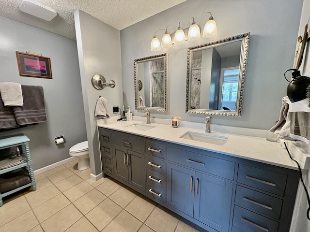 full bath with a sink, tile patterned flooring, a tile shower, and toilet