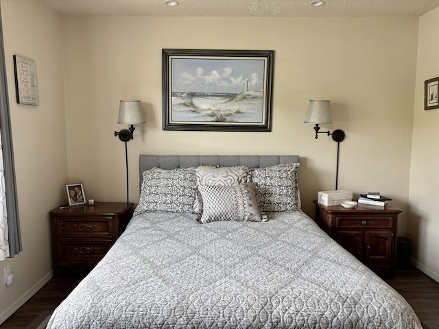 bedroom featuring baseboards and wood finished floors