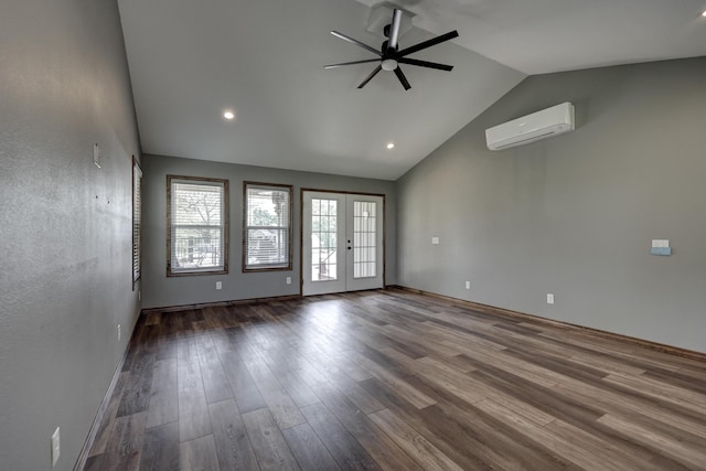 unfurnished room with wood finished floors, recessed lighting, a wall unit AC, french doors, and a ceiling fan