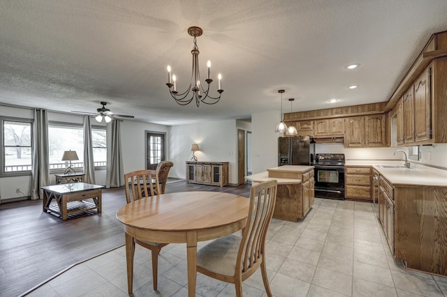 dining area with recessed lighting, a textured ceiling, ceiling fan with notable chandelier, and light tile patterned floors