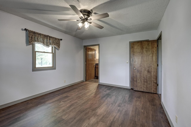 unfurnished bedroom with baseboards, a textured ceiling, and wood finished floors