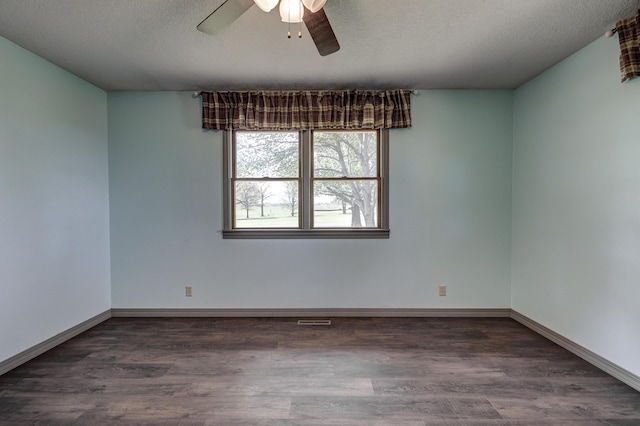 spare room with visible vents, wood finished floors, baseboards, ceiling fan, and a textured ceiling