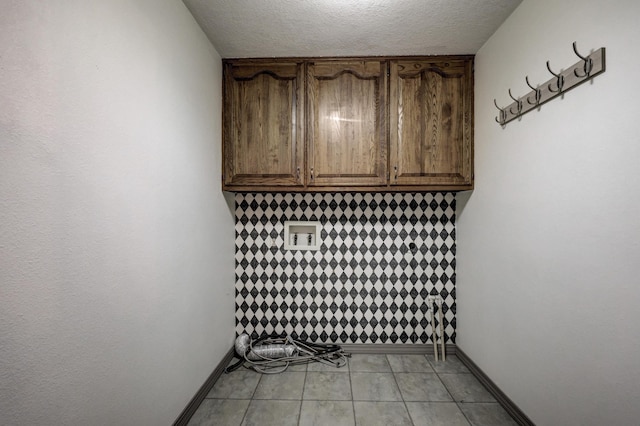 interior space with a textured ceiling and baseboards