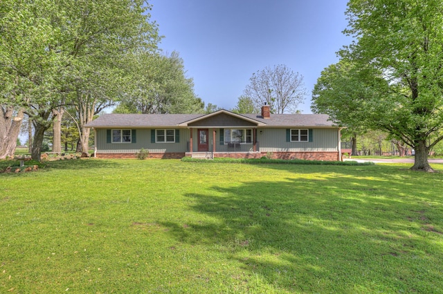 single story home featuring a porch, a front lawn, roof with shingles, and a chimney