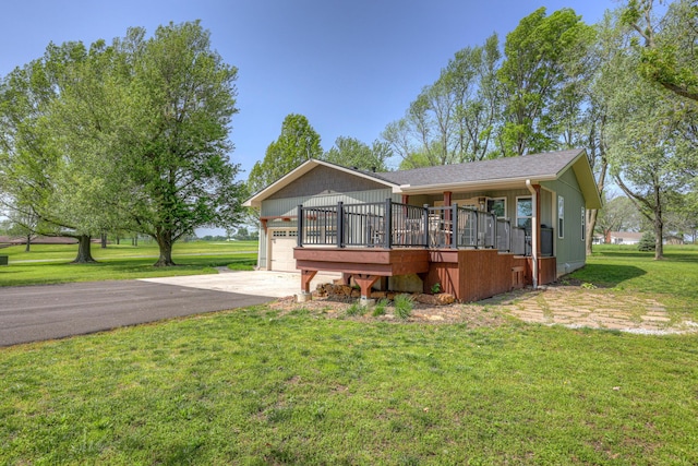 view of front of house with an attached garage, driveway, and a front yard