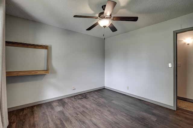 unfurnished room featuring dark wood-style flooring, ceiling fan, baseboards, and a textured ceiling