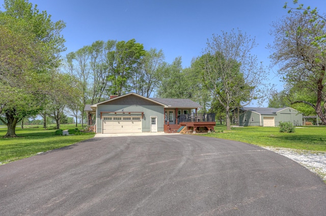 view of front facade featuring a front lawn, a garage, a deck, a chimney, and driveway