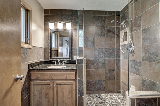 bathroom featuring vanity, walk in shower, and tile walls