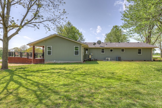 rear view of house with a lawn, crawl space, central air condition unit, and a wooden deck