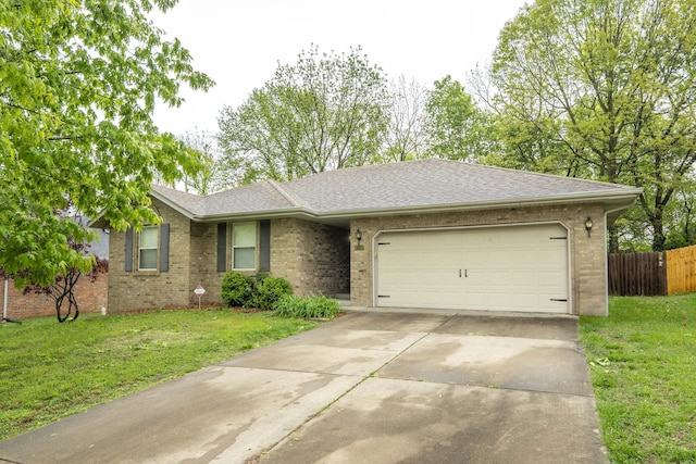 single story home featuring a garage, driveway, a front lawn, and brick siding