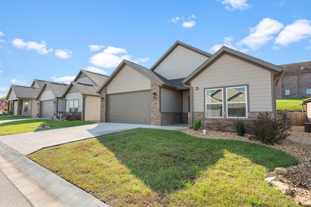 451 Stillwood Dr, Branson, MO 65616 - view of front of home featuring an attached garage, concrete driveway, a front yard, and brick siding