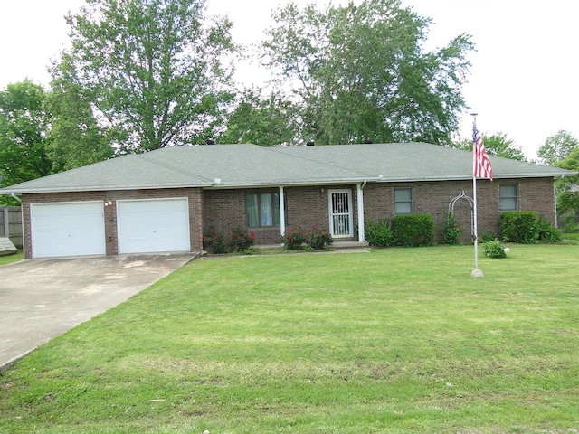 ranch-style home with brick siding, a garage, a front lawn, and concrete driveway
