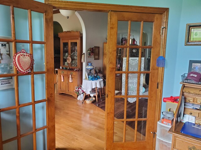 interior space featuring arched walkways and wood finished floors