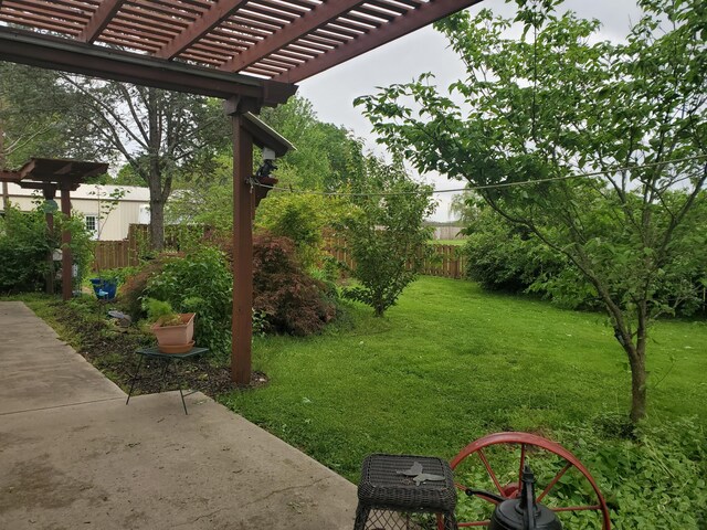 view of yard featuring a pergola, fence, and a patio