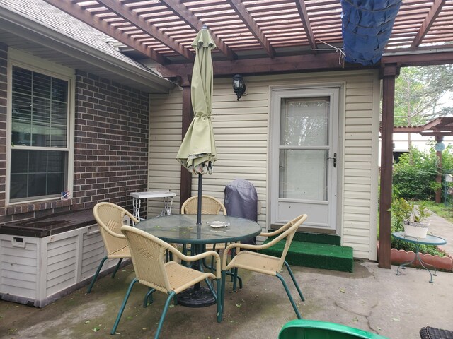 view of patio / terrace with entry steps, a pergola, and outdoor dining space