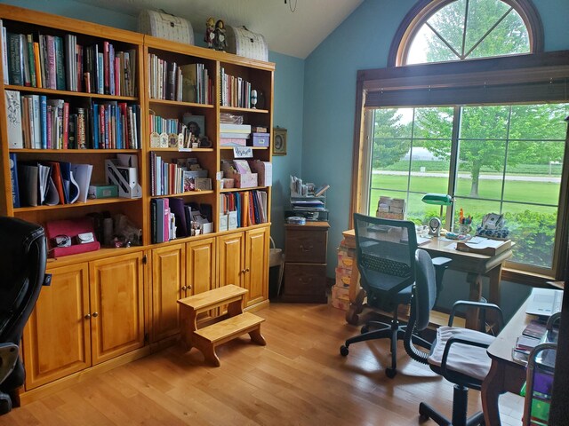 office featuring light wood-style flooring and lofted ceiling