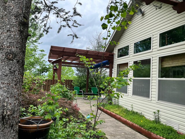 exterior space with a pergola and fence