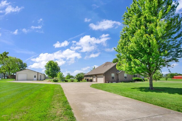 3538 E State Highway Aa, Springfield, MO 65803 - view of front of home with a garage, a front lawn, and brick siding