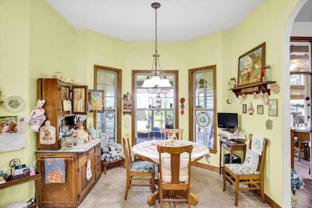 3538 E State Highway Aa, Springfield, MO 65803 - dining room featuring arched walkways, baseboards, and a chandelier