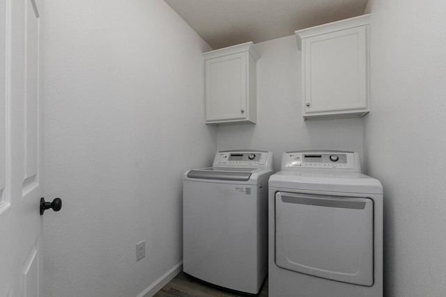 laundry room featuring baseboards, cabinet space, and washer and dryer
