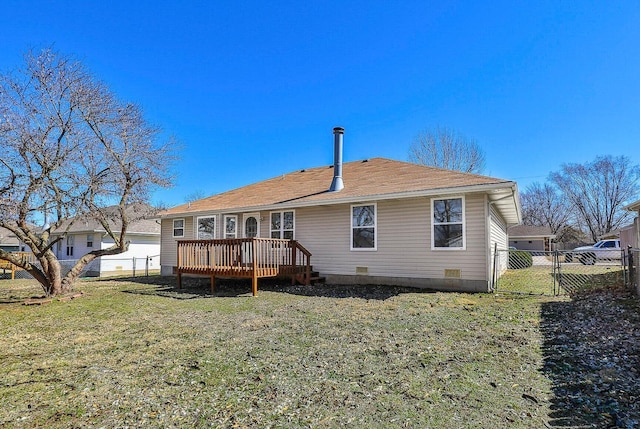 rear view of property featuring a lawn, fence, a wooden deck, and a gate