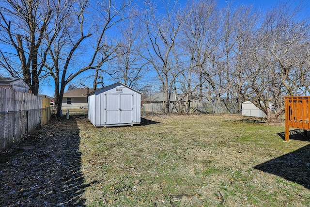 view of yard featuring a fenced backyard, an outbuilding, and a shed