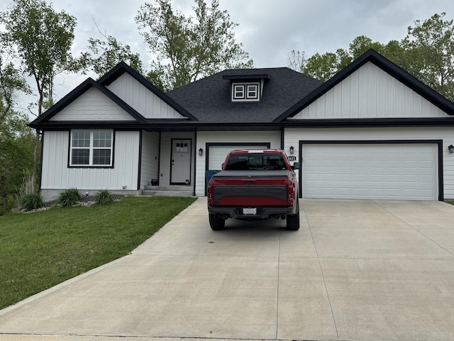 view of front of property with a shingled roof, an attached garage, concrete driveway, and a front lawn