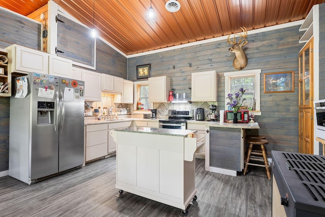 kitchen featuring a wealth of natural light, wooden ceiling, and stainless steel appliances