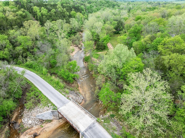 drone / aerial view featuring a view of trees