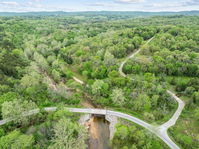 birds eye view of property featuring a view of trees