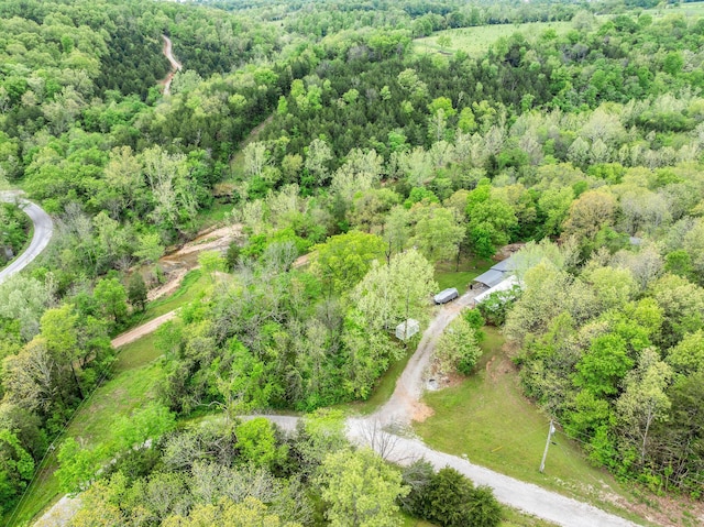 birds eye view of property with a wooded view