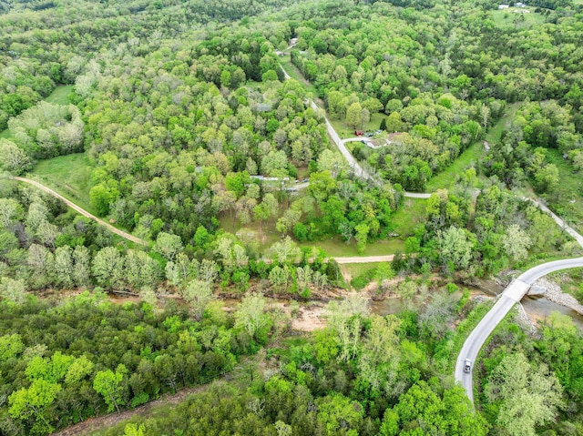 bird's eye view featuring a wooded view