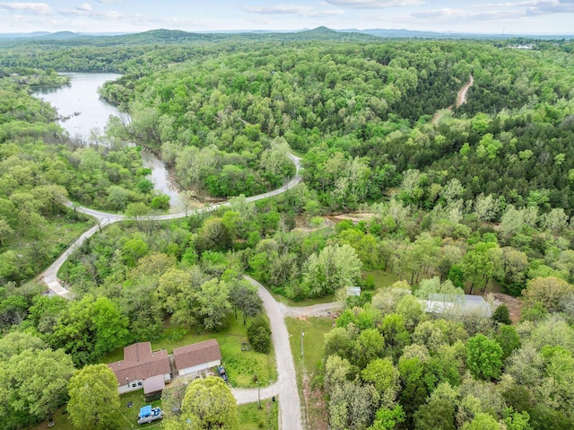 drone / aerial view featuring a water view and a forest view