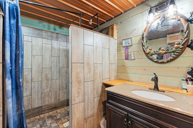 bathroom featuring wooden walls, vanity, and a tile shower