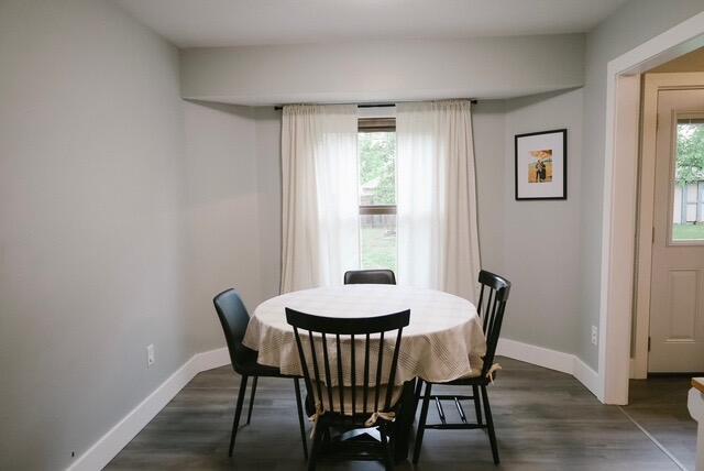 dining room with baseboards and dark wood finished floors