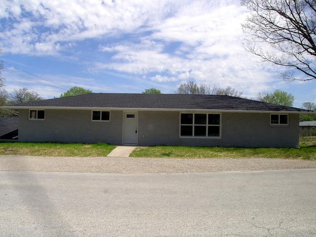 single story home featuring brick siding