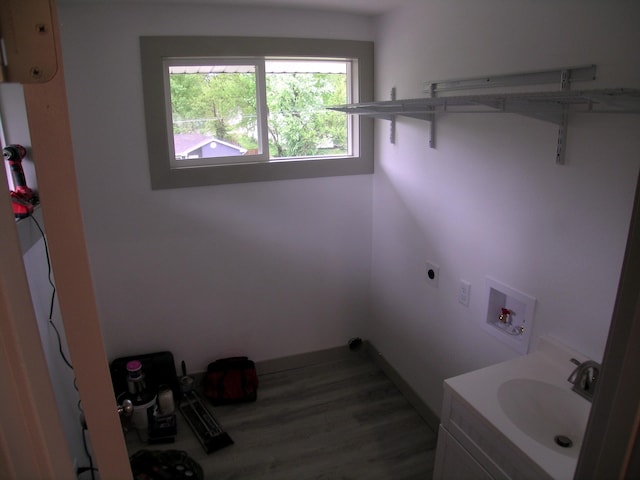 laundry area featuring hookup for an electric dryer, a sink, washer hookup, and wood finished floors