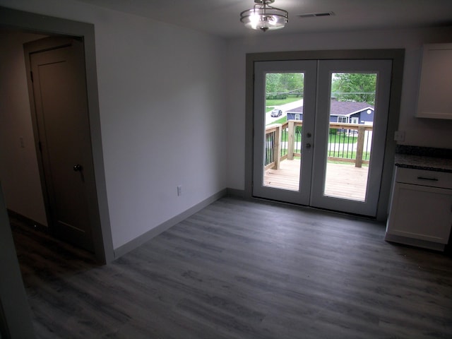entryway with baseboards, visible vents, french doors, and dark wood-type flooring