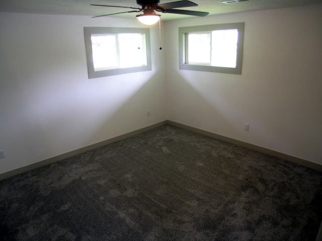 unfurnished room with carpet floors, plenty of natural light, baseboards, and ceiling fan