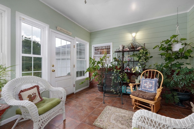 sunroom featuring tile patterned flooring and crown molding