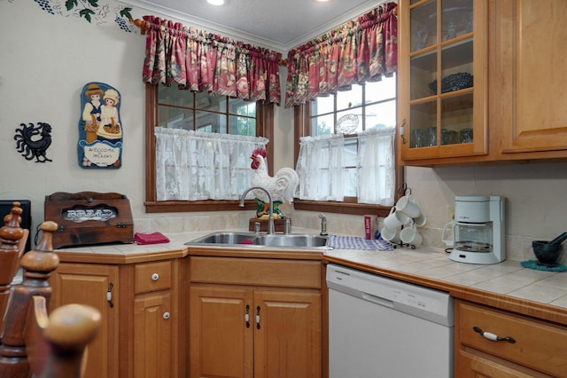 kitchen featuring white dishwasher, a sink, glass insert cabinets, and ornamental molding
