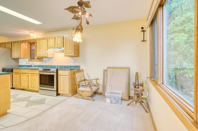 kitchen with under cabinet range hood, stainless steel appliances, a wealth of natural light, and light brown cabinets