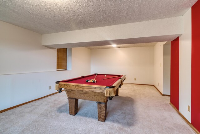 recreation room featuring pool table, baseboards, carpet flooring, and a textured ceiling